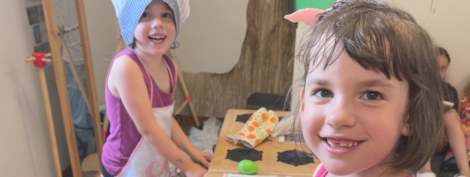 Relief Nursery classroom friends playing in the kitchen